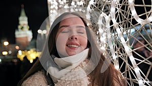 Happy girl on the background of Christmas garland.