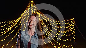 Happy girl on the background of night party illumination