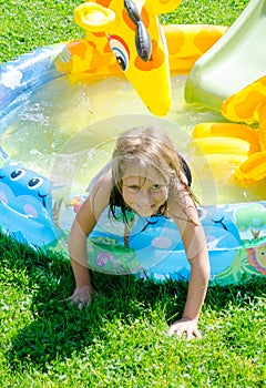 Happy girl in blowup pool