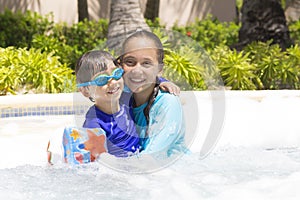 Happy Girl and Boy Enjoying in Swimming Pool