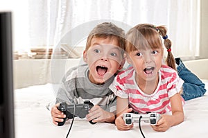 Happy girl and boy playing a video game