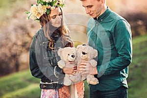 Happy girl with boyfriend and two plush teddy bear.