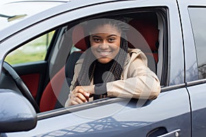 Happy girl in a car driving, African American