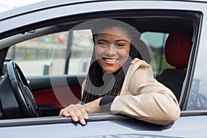 Happy girl in a car driving, African American