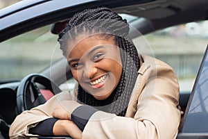 Happy girl in a car driving, African American