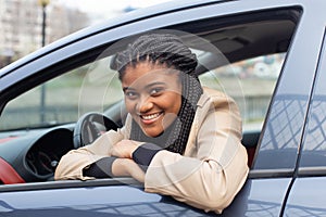 Happy girl in a car driving, African American