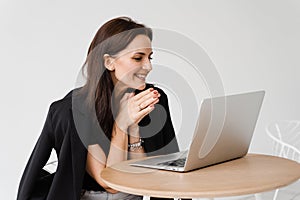 Happy girl chatting with family and friends via video call on white background. Successful business woman with laptop