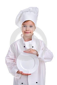 Happy girl chef white uniform isolated on white background. Holding the white plate in the hands in front of herself