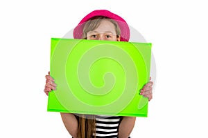 Happy girl child and hiding under empty blank paper isolated on white background. copy space