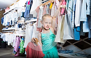 Happy girl in children clothes shop