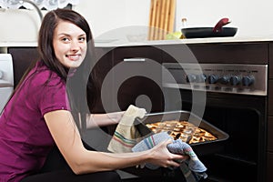 Happy girl with cooked pie