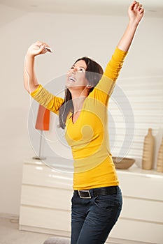 Happy girl dancing with earphones