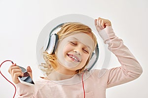 Happy girl dancing while listening to music