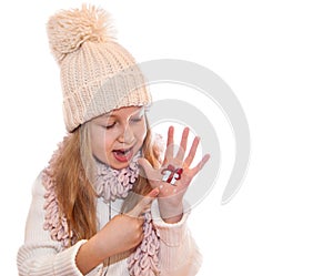 Happy girl demonstrating Christmas symbols painted on hands. Christmas present