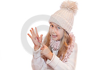 Happy girl demonstrating painted Christmas symbols on her hands. Santa Claus, Reindeer
