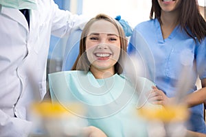 Happy girl in dental chair when pain stopped