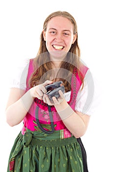 Happy girl in dirndl hanging up the phone