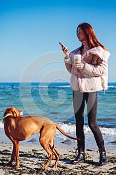 Happy Girl with a dog at the sea
