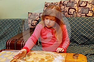 Happy girl with Down syndrome bakes cookies