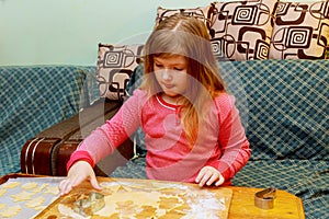 happy girl with Down syndrome bakes cookies