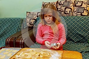 happy girl with Down syndrome bakes cookies