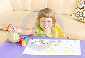 The happy girl draws paints