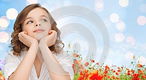 Happy girl dreaming over poppy field background photo