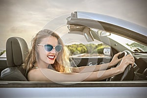 Happy girl driving a car