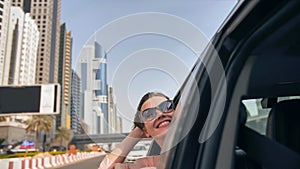 Happy Girl driving a car in Dubai.