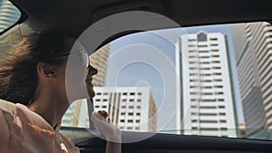 Happy Girl driving a car in Dubai.