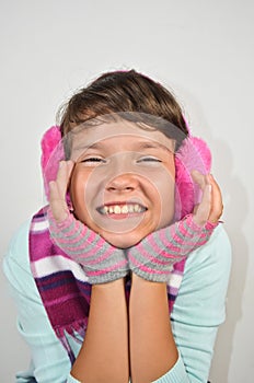 A happy girl with ear muffs and trimmed gloves photo