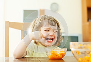 Happy girl eating carrot salad