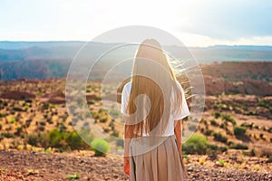 Happy girl on the edge of the cliff at Horseshoe Band Canyon in Page, Arizona. Adventure and tourism concept. Beautiful