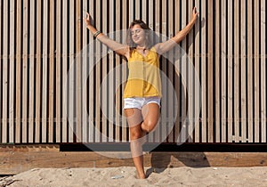 Happy girl enjoying freedom in the sun at the beach