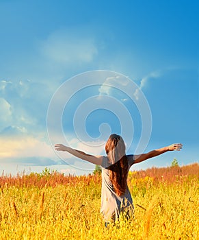 Happy girl enjoying the happiness on sunny meadow