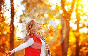 Happy girl enjoying life and freedom in the autumn on nature