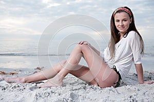 Happy girl enjoys sunny day at the beach.