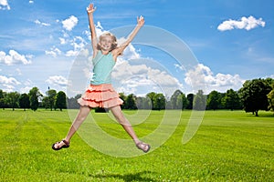 Happy girl enjoys warm summer day outside.