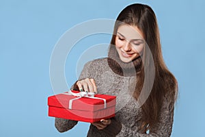 Happy girl in excitement opening Christmas box