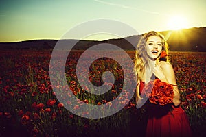 Happy girl in field of poppy seed