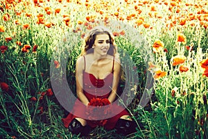 Happy girl in field of poppy seed