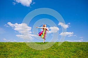 Happy girl fleeing on a meadow.