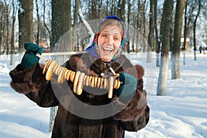 Happy girl in fur coat with round cracknel