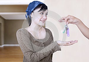 Happy girl given house key - indoor