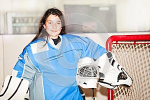 Happy girl goaltender posing after hockey match photo