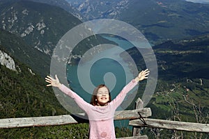 Girl with hands up on a fantastic viewpoint Banjska Stena Tara mountain Serbia photo