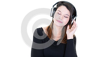 Happy girl with headphones closed eyes standing on white background