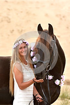 Happy girl and her black Frisian horse