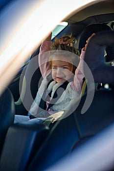 Happy girl in her car seat