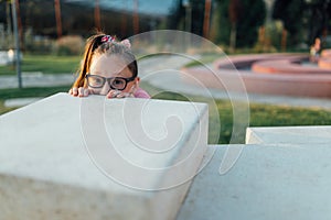 Happy girl is hiding in the park